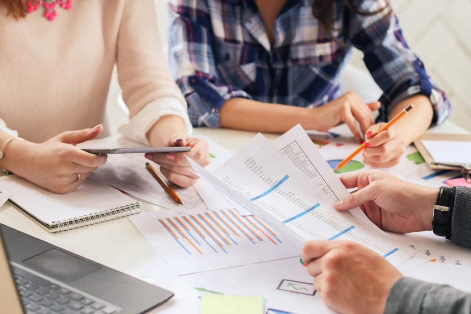 Professional financial analysis workspace with charts and planning documents